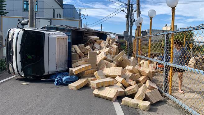 陈姓货车司机快速通过路口后惨遭追撞，翻车后成綑金纸掉落满地。（民眾提供／谢琼云彰化传真）