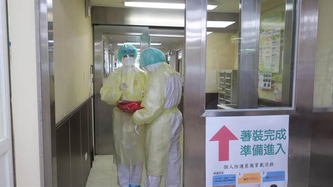 要进出负压隔离病房，护理站护理师们得穿上两层密不透风的防护服，加上头套、鞋套和手套，每次进出后内层护士服总是被大量汗水湿透，还得全身大清消才能回到护理站。（谢琼云摄）