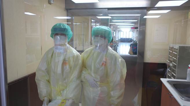 要进出负压隔离病房，护理站护理师们得穿上两层密不透风的防护服，加上头套、鞋套和手套，每次进出后内层护士服总是被大量汗水湿透，还得全身大清消才能回到护理站。（谢琼云摄）