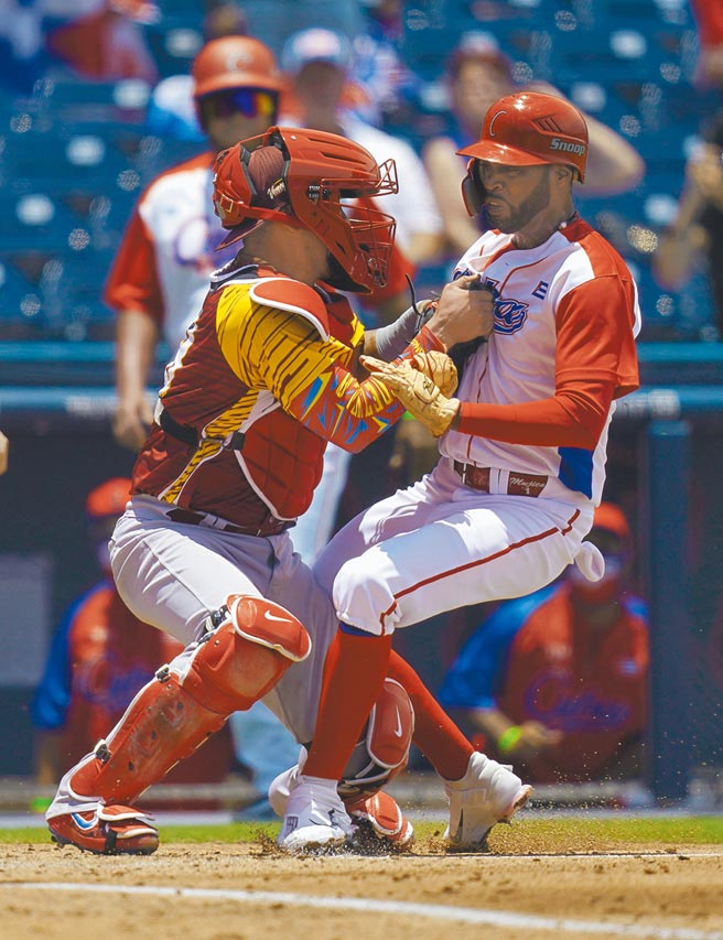 古巴隊跑者穆西卡（右）1局下硬闖本壘，被委內瑞拉捕手奇里諾斯觸殺出局。（路透）