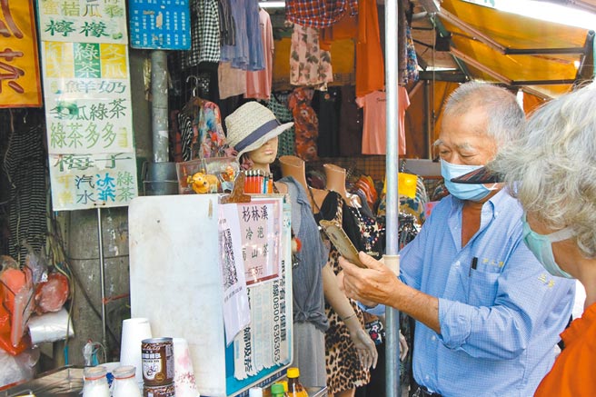 嘉义市共和市场推实联制，长辈也学用手机扫描QR Code。（嘉义市政府提供／廖素慧嘉市传真）
