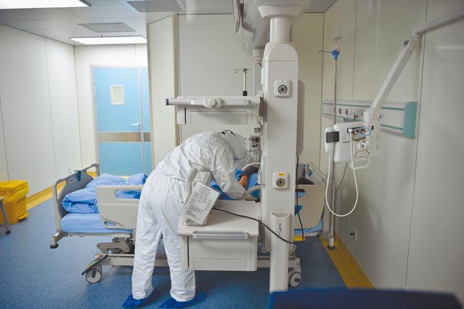 大陆国务院要求建立分级分层分流的重大疫情救治体系。图为云南省新冠肺炎定点收治医院，医护人员在负压病房照顾病人。（中新社）