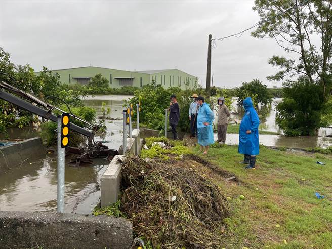 麻豆井东里里长吴建霖、安正里里长李胜忠冒着大雨安排机械车辆清理大排水沟。（读者提供／刘秀芬台南传真）