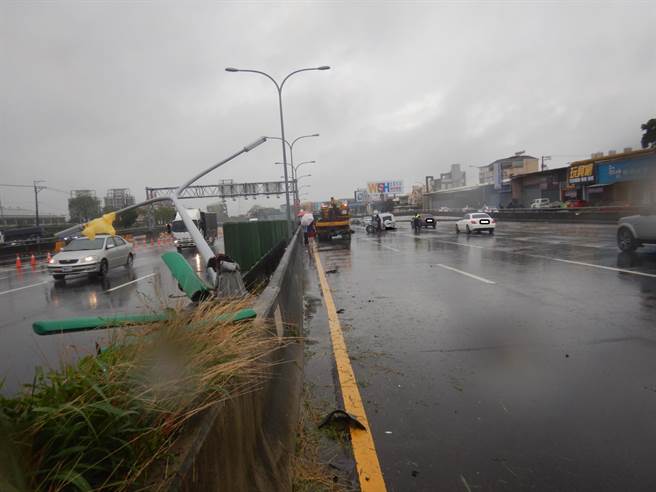 驾驶向警方表示，因为路面积水所以造成车辆失控，打滑撞到中央分隔岛，再将路灯撞断。（民眾提供／卢金足台中传真）