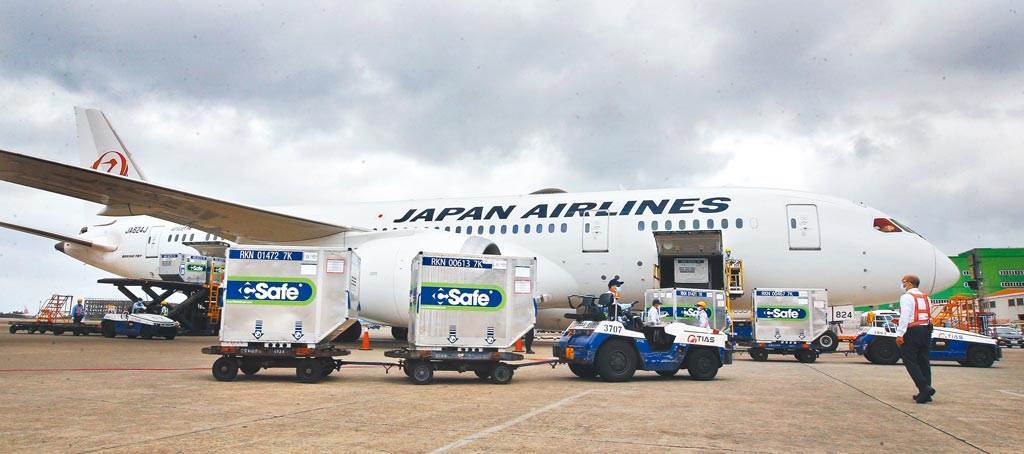 日本捐贈台灣首批124萬劑AZ疫苗，6月4日由日航班機運抵桃園機場，圖為地勤人員一一卸下疫苗的冷凍貨櫃。（圖／本報系資料照）