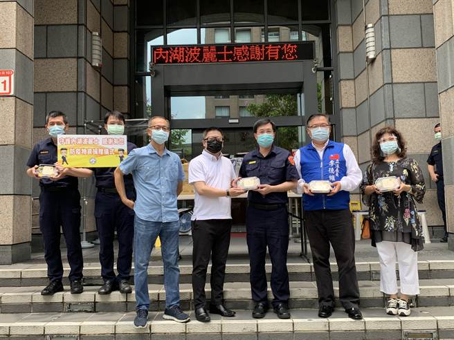 北市内湖分局分局长王宝章(右三)接受理事长郭煜杰(左四)捐赠养生健康餐盒等物资。(翻摄照片／林郁平台北传真）