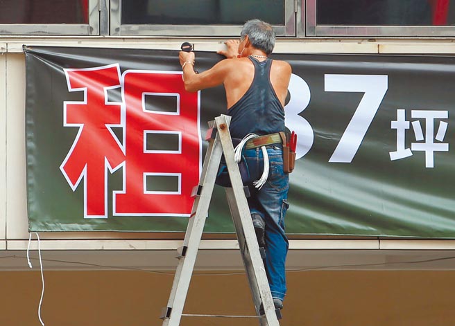 全国三级警戒管制至28日，势必影响内需产业。图为北市东区街头工人架设店面出租广告。（赵双杰摄）