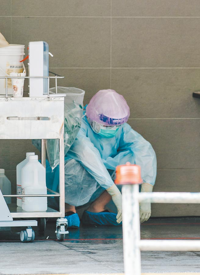 国内疫情严重，除了共同投疫，更需要疫苗来保护国人。图为北市筛检站医护人员累到只能蹲着休息片望，站起来又继续拚。（本报资料照片）