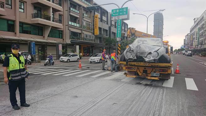 賓士車自撞後起火，現場噴灑滅火器。（程炳璋攝）