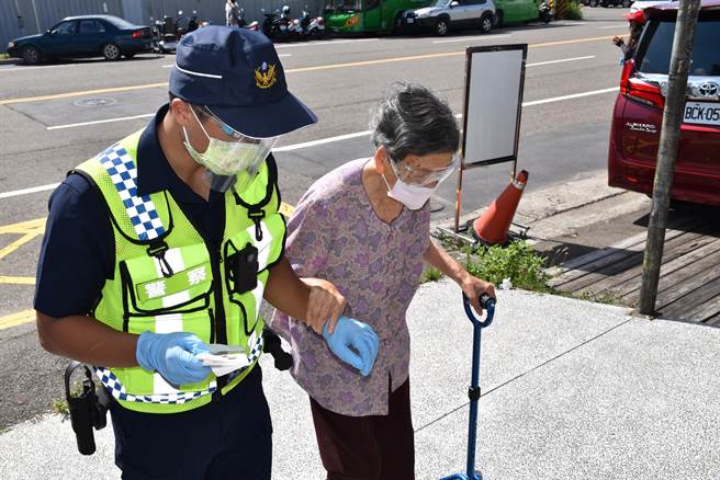 15日正值警察節，苗栗縣警局頭份分局派員警在場協助行動不便老人，場景相當感人。（謝明俊攝）