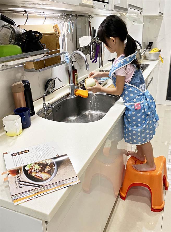学童停课在家的日子，成了妈妈厨房里的小帮手。（林和生摄）