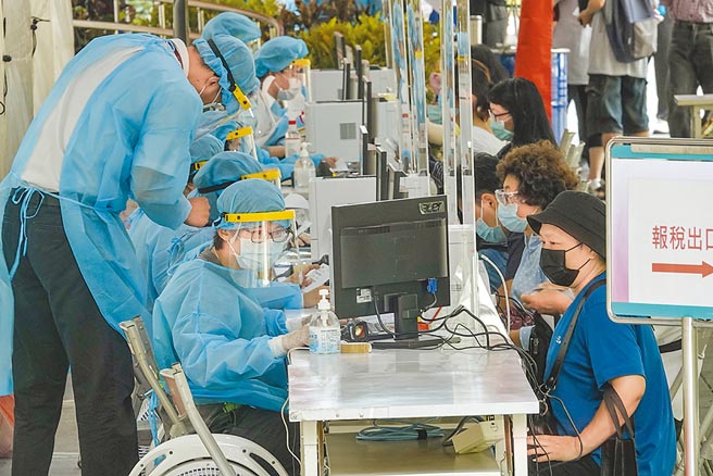 2021年报税只剩最后半个月，许多民眾15日到台北信义行政中心外申报站报税，受疫情升级三级警戒影响，受理申报的国税局人员配备医护人员相同等级防护装备。（黄子明摄）