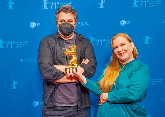 导演哈都裘德（左）日前戴黑口罩上台领柏林金熊奖，右为女制片。（海鹏提供）