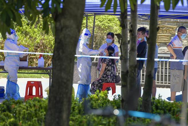 中國駐埃及大使館公布，6月13日至6月19日，自埃及赴華航班共兩班次，分別為6月15日埃及航空開羅-杭州航班、6月18日四川航空開羅-成都航班。該兩架次航班閉環人員共計484人，閉環管理期間在「交叉雙檢測」中核酸及血清抗體檢測結果呈陽性人員共計108人。圖為身穿防護服的醫護人員對海口某小區居民開展核酸檢測。（中新社）