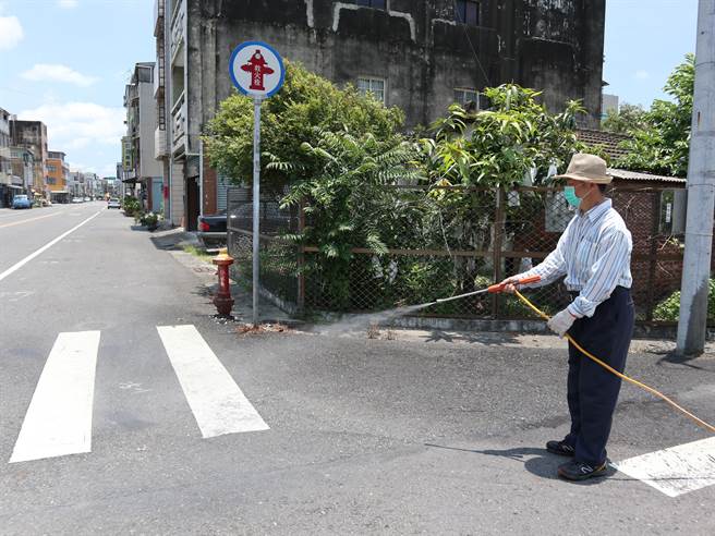 台南市学甲夜市14日復业首日，营业前夜市管委会长凃志宏到现场大消毒。（张毓翎摄）