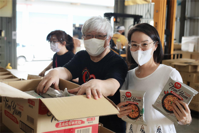 「瓦城慈善基金会」执行长吴丹凤与「1919食物银行」秘书长夏忠坚牧师一起为弱势打包防疫物资。(图/瓦城慈善基金会提供)