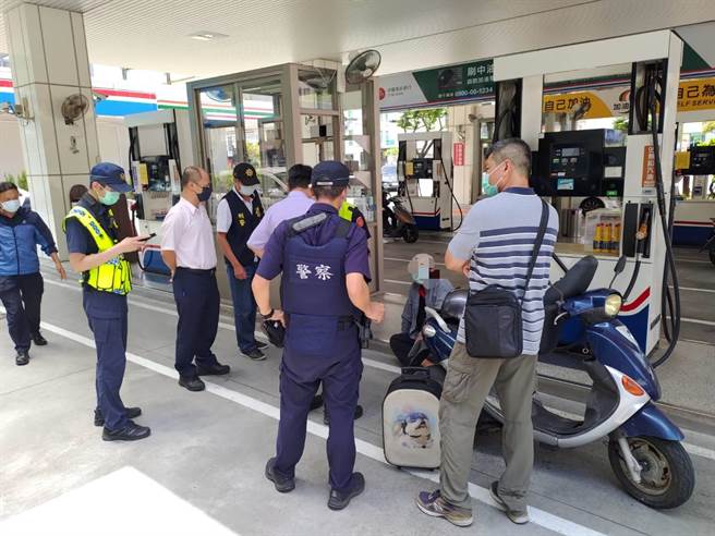 郑姓男子（蹲坐者）因疫情影响失业铤而走险，行抢加油站，饭后坐在地上等警察逮捕。（读者提供／程炳璋台南传真）