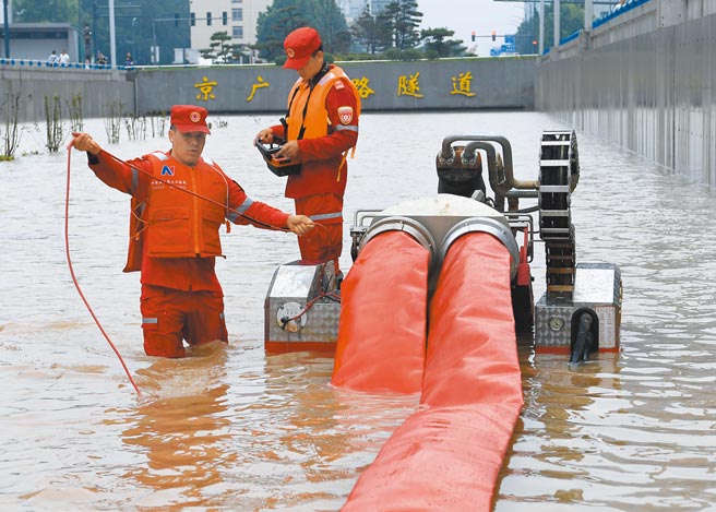 大陸河南鄭州連日遭遇暴雨，鄭州市區內的京廣路隧道，20日5分鐘內就被淹平，救援人員22日在隧道口進行排澇作業。（新華社）