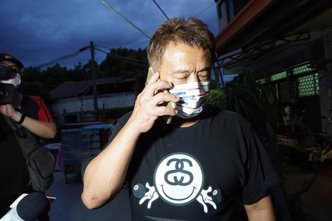 杨勇纬父亲忙着接道贺电话。（王文吉摄）