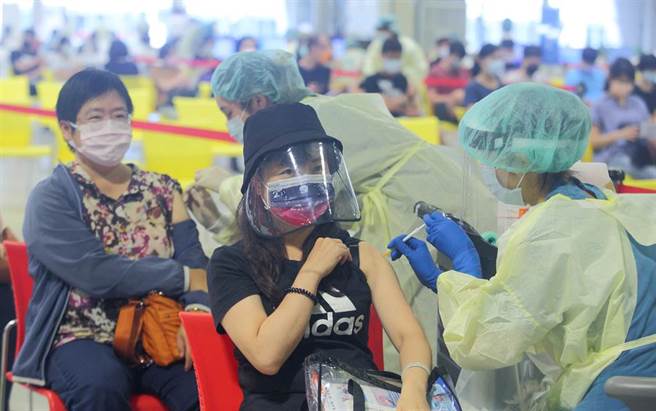 中央流行疫情指挥中心指挥官陈时中27日宣布，「COVID-19疫苗施打意愿登记与预约系统」重新开放让还没有接种意愿登记的人，并提供「高端疫苗」做为新选项，让民眾可以先行登记，护理师以两人一组的方式，27日在北市花博接种站施打疫苗，使效率加倍。（张铠乙摄）