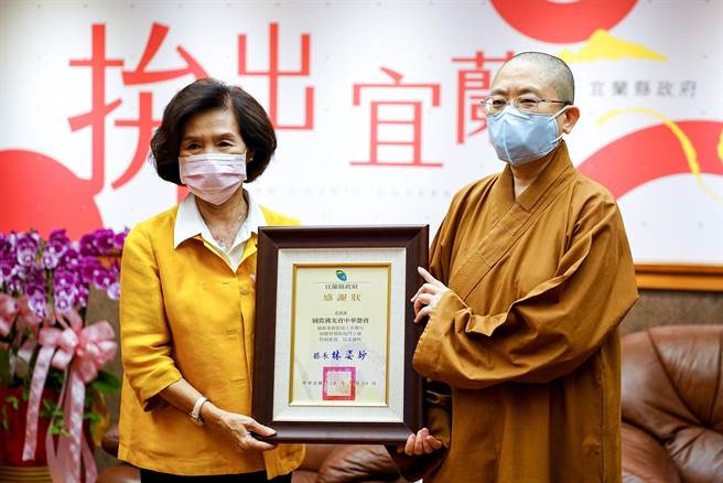 佛光会捐赠宜兰县政府2座智慧防疫门，今天县长林姿妙（左）致赠感谢状，由兰阳别院住持妙勤法师代表接受。（李忠一摄）