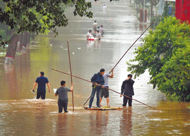 受到极端气候影响，大陆多地雨量频创纪录，有33个国家气象站日降水量突破歷史极值，洪涝灾害严重。图为河南省卫辉市村民积极救灾。（新华社）