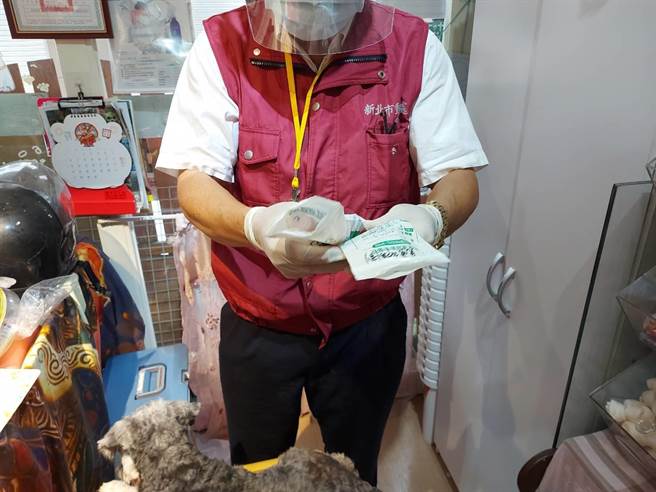 新北市動保處獸醫檢視Echo的藥袋了解病史狀況。（新北市動保處提供）