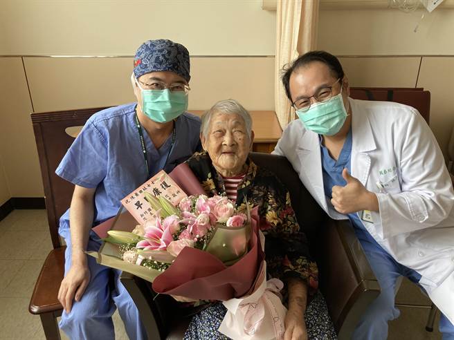 108歲的人瑞級陳蕭阿嬤（中）接受摘除卵巢囊腫手術，出院時醫師們送上花束祝賀。（新竹國泰醫院提供／邱立雅竹市傳真）