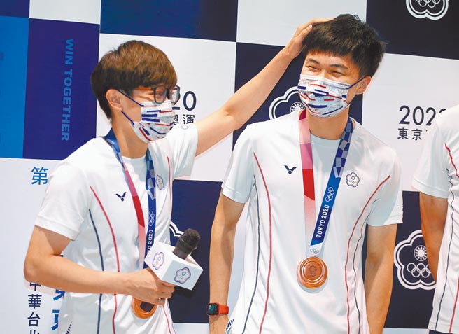 东奥桌球及拳击选手6日返台，林昀儒（左二）及郑怡静（左）受访时，大家鼓噪要两人拥抱庆祝，但是郑怡静害羞地摸摸林昀儒的头「意思到就好」。（范扬光摄）