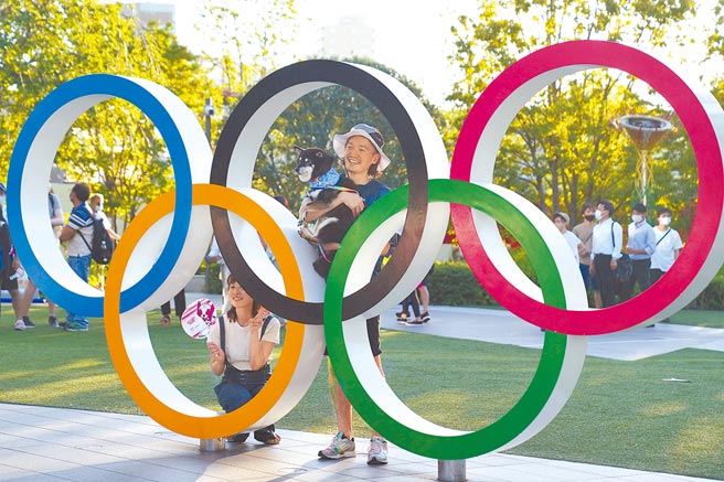 白俄罗斯短跑女将齐玛诺斯卡雅被迫离开东奥，幸好在波兰与人权组织协助下安抵波兰首都华沙，鼓励其他受压迫的国人，「不要怕，大声说出来。」图为日本东京国立竞技体育场外，日本民眾排队与五环合影。（中新社）