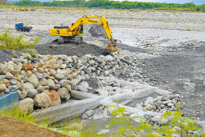 台东山区连日大雨，滚滚洪水冲坏池上圳取水口土堤，怪手忙着砌边坡修復。（蔡旻妤摄）