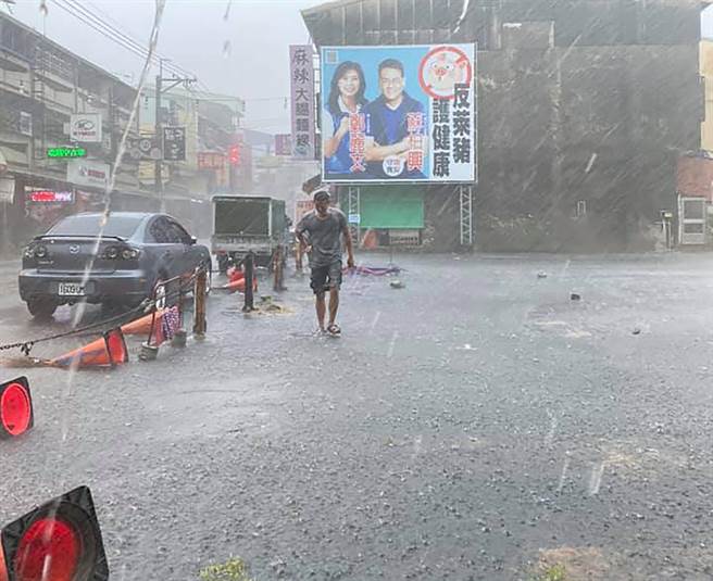 台中市下午3点半左右，突然来了一阵狂风暴雨，水像用倒的一样，道路立即积水，一位民眾拍下，一位摊商与大雨搏斗的情况。（翻摄自大里人聊天室脸书／黄国峰台中传真）