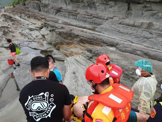 年约40多岁男子偕妻子今（10日）下午5时许，违规闯入新北市贡寮区龙洞海水浴场浮潜，男子于礁石上不慎滑倒，造成右小腿骨折。（翻摄）