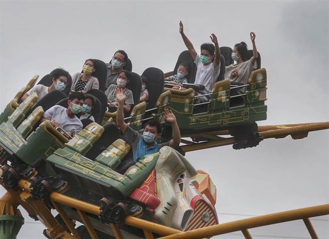 小朋友与家人愉快的使用游乐器材。（王英豪摄）