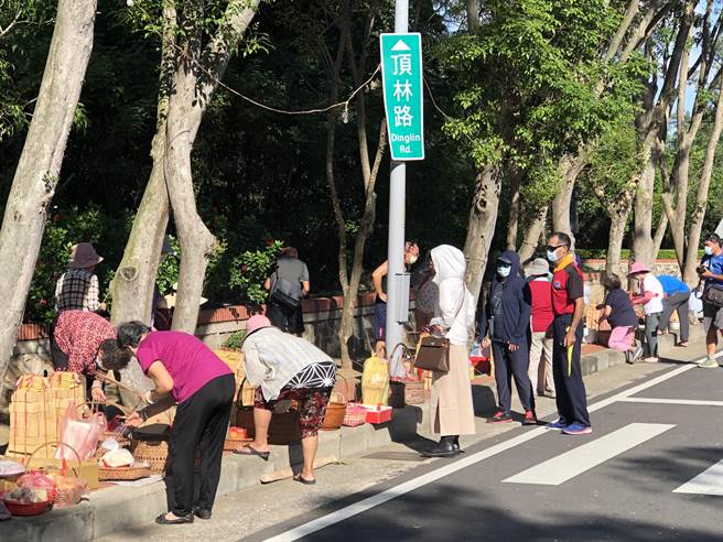 古寧村民在农历7月8日齐备丰盛菜肴，席地虔敬「路祭」国共阵亡官兵，抚慰长眠地下的两岸英灵。（李金生摄）