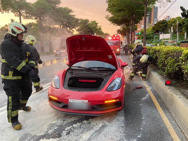 一輛紅色保時捷保車今（15日）下午6時許，行經新北市淡水區中正東路二段、往北市方向，疑因不明原因車頭不斷冒出白煙。（翻攝）