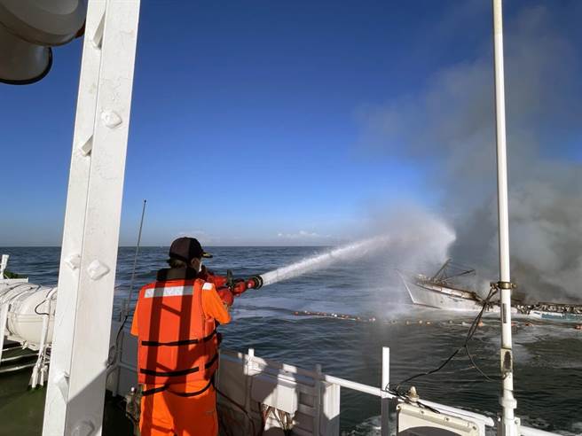 海巡署舰队分署第四海巡队人员以消防高压水柱救援渔船火警。（第四海巡队提供／洪荣志台南传真）
