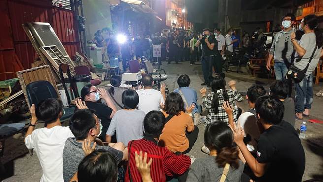 黄家抗拆声援学生聚集铁皮墙下静坐，面对警方举牌驱离。（程炳璋摄）