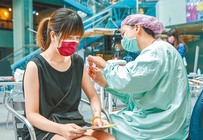 国产高端疫苗开打，预计将于本周完成7万人接种。24日科教馆的接种站内，护理人员正为民眾施打疫苗。(粘耿豪摄)