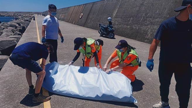安平渔港29日发现浮尸卡消波块，海巡与警消携手安置遗体。（海巡署提供）