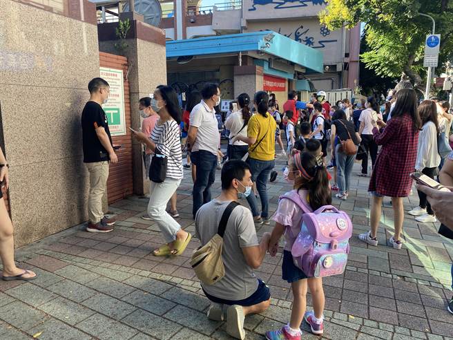 一早许多家长就带着孩子到校门口，叮咛孩子上课的注意事项。（游念育摄）