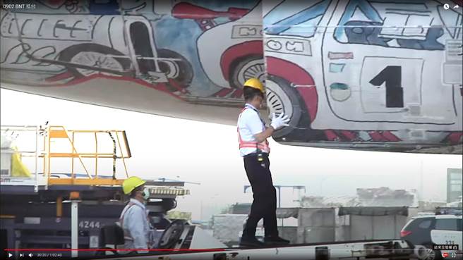 首批辉瑞／BNT疫苗约93.2万剂今早7时由卢森堡货运航空CV7962货机运抵桃园机场，原本在卢森堡启运时，货物上绑有的「復必泰」布条，结果抵台后却在出舱前，「復必泰」布条离奇消失，据了解，桃勤人员在海关尚未审查核对舱单货物前，就被授意先「闪进」货舱拆布条。（直播截图）