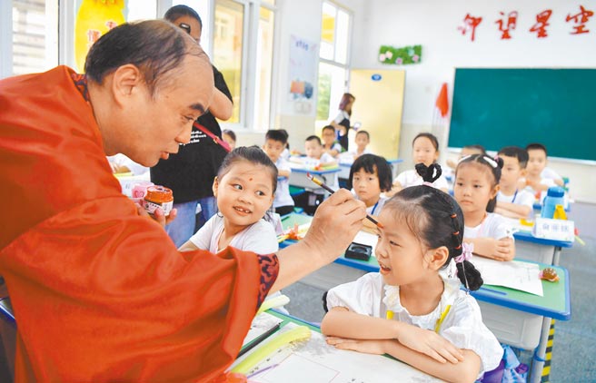 9月1日也是大陆学校开学日，福州市仓山区第六中心小学老师为一年级新生点朱砂。（中新社）