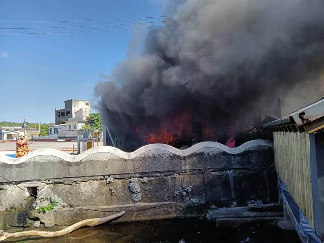 新北市石门区老梅绿石槽停车场旁仓库今（7日）下午2时许突然起火燃烧，火势燃烧猛烈，火舌瞬间吞噬整间仓库。（翻摄）