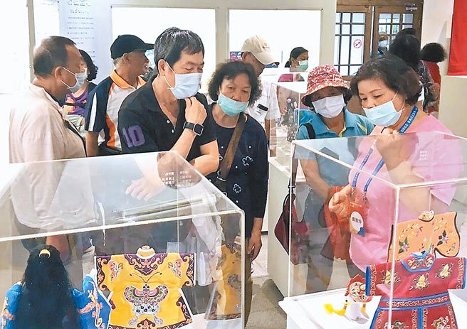 屏县文化志工（右）穿梭展场，仔细解释展览内涵。（屏县府提供／林和生屏东传真）