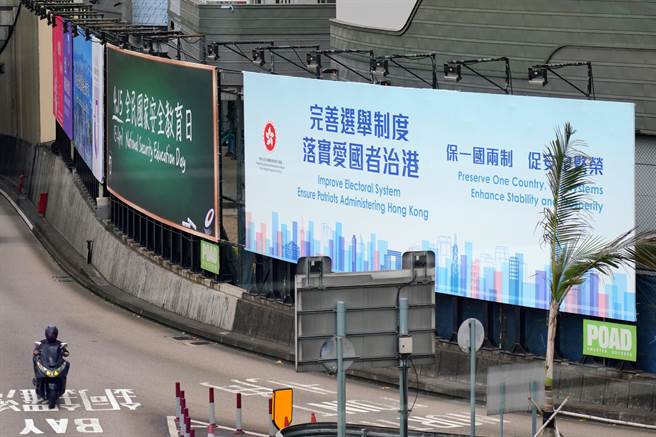 今年1月起，香港特区政府要求全体现职公务员宣誓或签署声明拥护《香港基本法》及效忠香港特区。图为香港红磡海底隧道港岛出口的“完善选举制度 落实爱国者治港”巨幅广告牌（中新社）