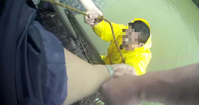 尤姓男子坠落约2米深大排水沟中，警方将桌脚降至2米深的排水沟中，让尤男踩踏垫高后，再用绳索将他拉上岸。（警方提供／林雅惠高雄传真）