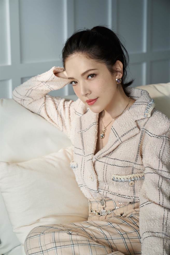 女星许玮宁穿着香奈儿 2021／22 秋冬前导系列米色格纹羊毛斜纹软呢外套、米色格纹棉质宽裤，配戴淡紫色宝石金属圆形耳环、银色水晶镶饰坠式金属项炼。（香奈儿提供）