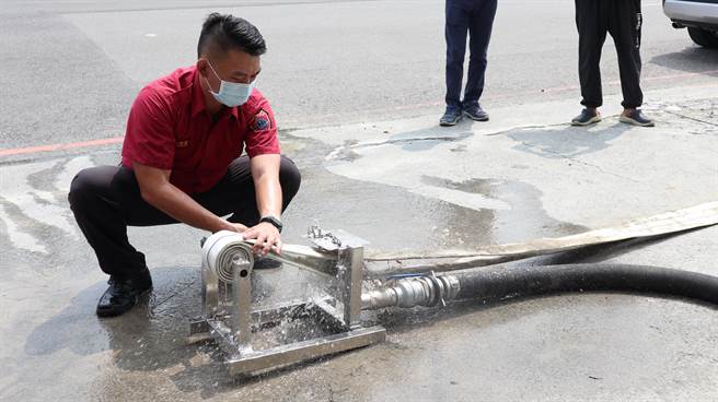 台南市消防局官田分队小队长陈至坤示范操作「水带清洗收纳机」。（张毓翎摄）