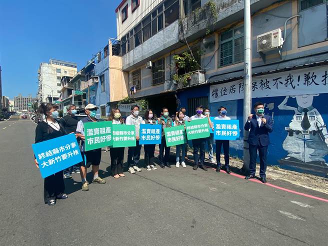 新竹市多位议员29日与抗议民眾在「警光一村」宿舍前，挂白布条高喊「滥卖祖产、市民好惨、终结县市分家」，痛陈县府罔顾居住权。（陈育贤摄）